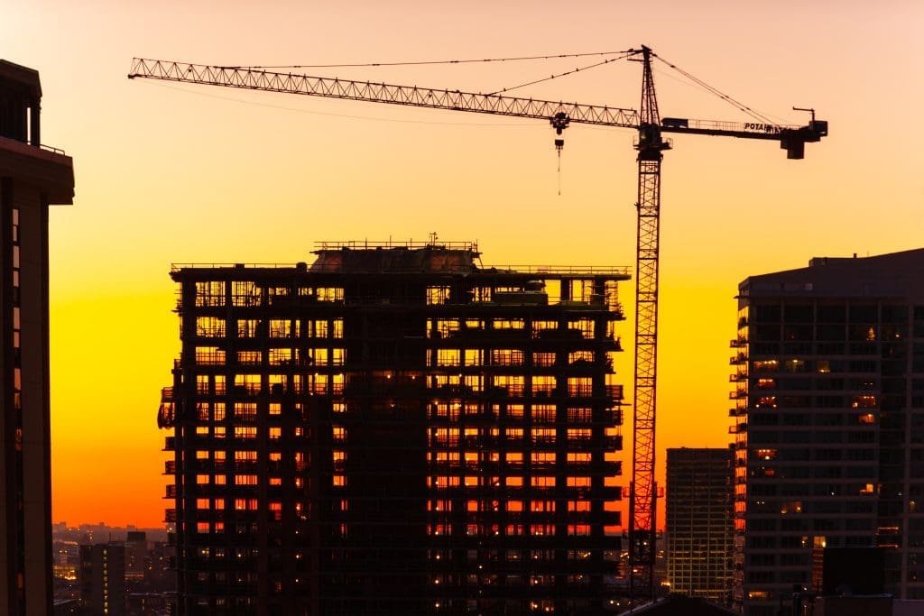 Cranes at sunset. Building under construction. 