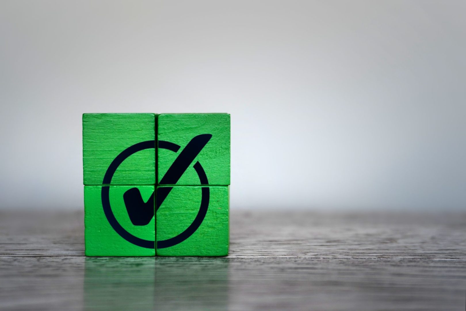 Green wooden cubes with checkmark icon.