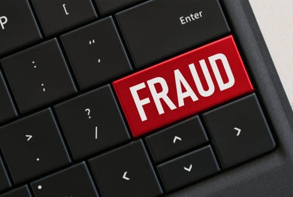 Mortgage fraud highlighted in red on a laptop keyboard's Shift key